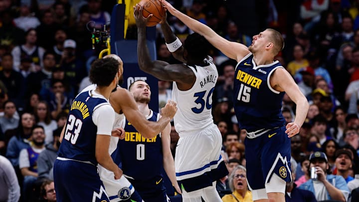 Apr 27, 2026; Denver, Colorado, USA; Minnesota Timberwolves forward Julius Randle (30) drives to the net against Denver Nuggets center Nikola Jokic (15) as guard Christian Braun (0) and forward Cameron Johnson (23) defend in the third quarter during game five of the first round of the 2026 NBA Playoffs at Ball Arena.