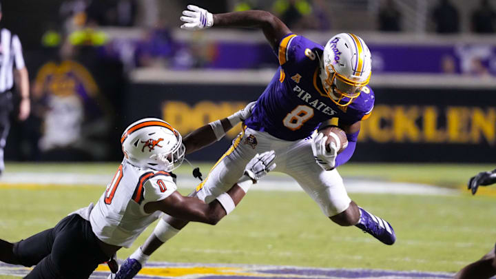 Sep 6, 2025; Greenville, North Carolina, USA; East Carolina Pirates tight end Jayvontay Conner (8) is hit after his catch against Campbell Fighting Camels safety Evan Spivey (0) during the second half at Dowdy-Ficklen Stadium. Mandatory Credit: James Guillory-Imagn Images