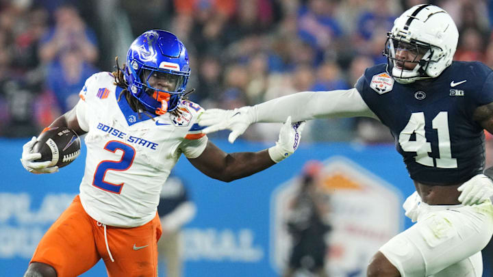 Ashton Jeanty stiff-arms Kobe King in Boise State's playoff game against Penn State.