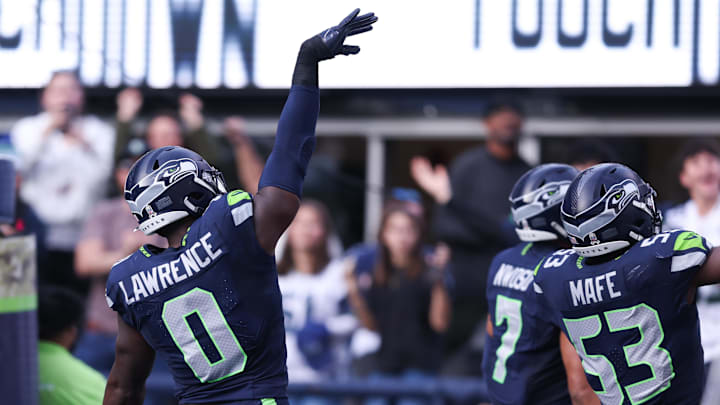 Nov 9, 2025; Seattle, Washington, USA; Seattle Seahawks defensive end DeMarcus Lawrence (0) celebrates after recovering a fumble to score a touchdown during the second quarter against the Arizona Cardinals at Lumen Field.
