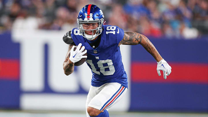 Aug 18, 2023; East Rutherford, New Jersey, USA; New York Giants wide receiver Isaiah Hodgins (18) gains yards after catch during the first half against the Carolina Panthers at MetLife Stadium. Mandatory Credit: Vincent Carchietta-Imagn Images 