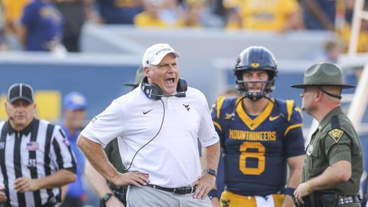 Sep 13, 2025; Morgantown, West Virginia, USA; West Virginia Mountaineers head coach Rich Rodriguez yells at the referee during the second quarter against the Pittsburgh Panthers at Milan Puskar Stadium. Mandatory Credit: Ben Queen-Imagn Images