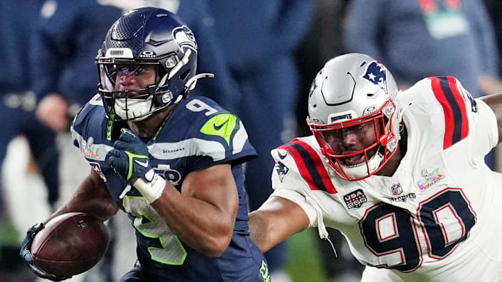 Feb 8, 2026; Santa Clara, CA, USA; Seattle Seahawks running back Kenneth Walker III (9) runs the ball as New England Patriots defensive tackle Christian Barmore (90) defends during the third quarter in Super Bowl LX at Levi's Stadium. Mandatory Credit: Cary Edmondson-Imagn Images