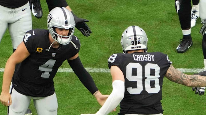Sep 26, 2021; Paradise, Nevada, USA; Las Vegas Raiders defensive end Maxx Crosby (98) is greeted by quarterback Derek Carr (4)a nd offensive guard John Simpson (76) before the game against the Miami Dolphins at Allegiant Stadium.The Raiders defeated the Dolphins 31-28 in overtime. Mandatory Credit: Kirby Lee-Imagn Images