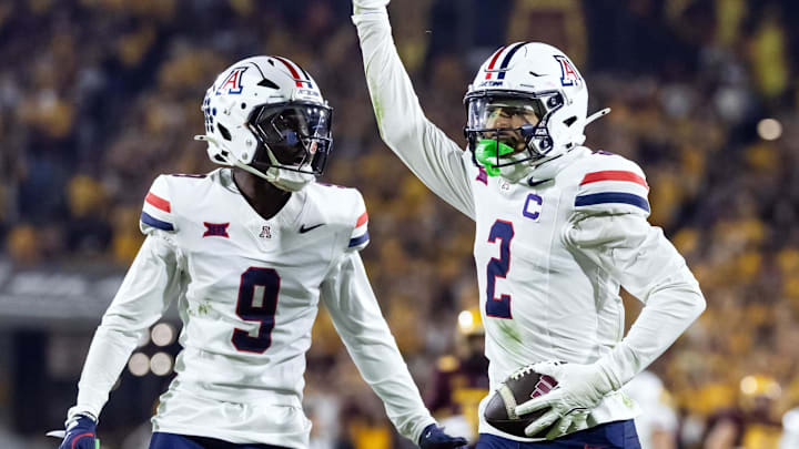 Nov 28, 2025; Tempe, Arizona, USA; Arizona Wildcats defensive back Treydan Stukes (2) celebrates with defensive back Ayden Garnes (9) after an interception against Arizona State Sun Devils in the second half during the 99th Territorial Cup at Mountain America Stadium. Mandatory Credit: Mark J. Rebilas-Imagn Images