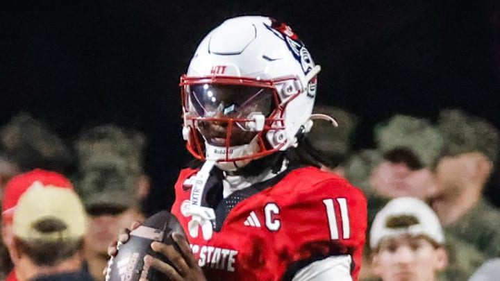 Nov 21, 2025; Raleigh, North Carolina, USA; NC State Wolfpack quarterback CJ Bailey (11) with the ball during the first half of the game against Florida State Seminoles at Carter-Finley Stadium. Mandatory Credit: Jaylynn Nash-Imagn Images Nov 21, 2025; Raleigh, North Carolina, USA; NC State Wolfpack quarterback CJ Bailey (11) with the ball during the first half of the game against Florida State Seminoles at Carter-Finley Stadium. Mandatory Credit: Jaylynn Nash-Imagn Images