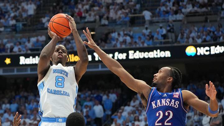 Nov 7, 2025; Chapel Hill, North Carolina, USA; North Carolina Tar Heels forward Caleb Wilson (8) shoots as Kansas Jayhawks forward Flory Bidunga (40) and guard Melvin Council Jr. (14) and guard Darryn Peterson (22) defend in the second half at Dean E. Smith Center. Mandatory Credit: Bob Donnan-Imagn Images Nov 7, 2025; Chapel Hill, North Carolina, USA; North Carolina Tar Heels forward Caleb Wilson (8) shoots as Kansas Jayhawks forward Flory Bidunga (40) and guard Melvin Council Jr. (14) and guard Darryn Peterson (22) defend in the second half at Dean E. Smith Center. Mandatory Credit: Bob Donnan-Imagn Images