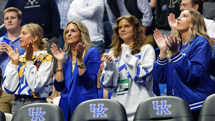 Nov 4, 2024; Lexington, Kentucky, USA; Lee Ann Pope, Kentucky Wildcats head coach Mark Pope’s wife, and daughters Ella, Avery and Layla, clap during intros before the game against the Wright State Raiders at Rupp Arena at Central Bank Center. Mandatory Credit: Jordan Prather-Imagn Images