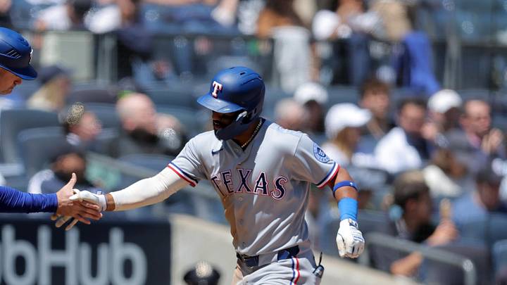 Texas Rangers left fielder Ezequiel Duran (20) high fives Texas Rangers third base coach Corey Ragsdale. 