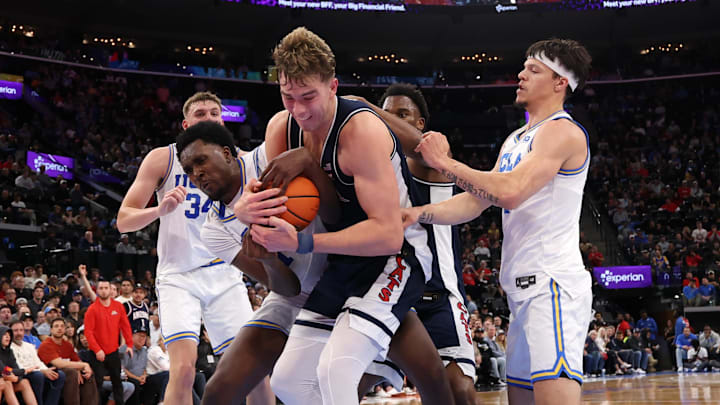 Nov 14, 2025; Inglewood, California, USA;  Arizona Wildcats center Motiejus Krivas (13) and UCLA Bruins center Xavier Booker (1) fight for a rebound during the first half of the Hall of Fame Series game at Intuit Dome. Mandatory Credit: Kiyoshi Mio-Imagn Images