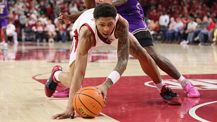 Arkansas Razorbacks guard Meleek Thomas 91) secures the ball during the second half against the James Madison Dukes at Bud Walton Arena in Fayetteville, Ark.