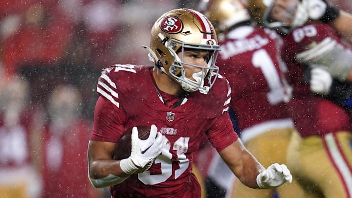 San Francisco 49ers running back Isaac Guerendo carries the ball.