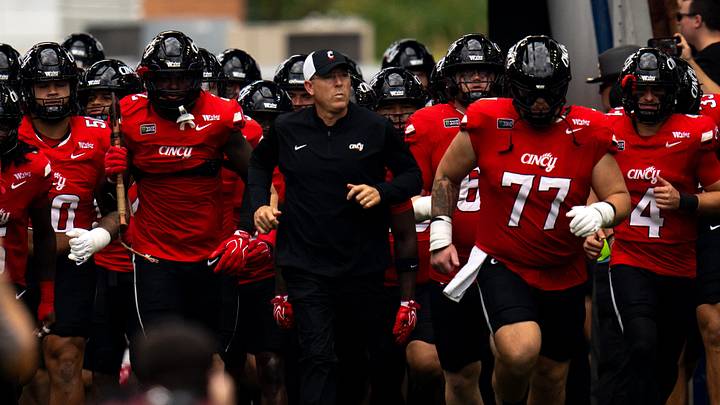 Cincinnati Bearcats head coach Scott Satterfield runs onto the field with the rest of the team before the football game between Cincinnati Bearcats and Miami RedHawks at Paycor Stadium in Cincinnati on Saturday, September 19, 2026. Cincinnati Bearcats head coach Scott Satterfield runs onto the field with the rest of the team before the football game between Cincinnati Bearcats and Miami RedHawks at Paycor Stadium in Cincinnati on Saturday, September 19, 2026.