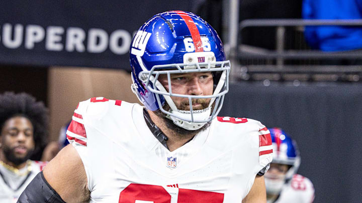 Oct 5, 2025; New Orleans, Louisiana, USA;  New York Giants guard Austin Schlottmann (65) runs out the tunnel against New Orleans Saints during warmups at Caesars Superdome. Mandatory Credit: Stephen Lew-Imagn Images