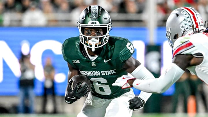 Michigan State's Nick Marsh, left, runs after a catch as Ohio State's Denzel Burke closes in during the second quarter on Saturday, Sept. 28, 2024, at Spartan Stadium in East Lansing.