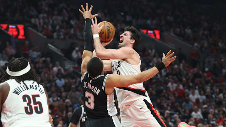 Portland Trail Blazers forward Deni Avdija shoots the ball over San Antonio Spurs forward Keldon Johnson during the first half during game three of the first round of the 2026 NBA Playoffs at Moda Center. Mandatory Credit: Jaime Valdez-Imagn Images