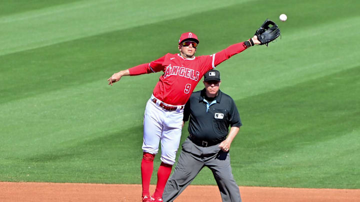 Feb 29, 2024; Tempe, Arizona, USA;  Los Angeles Angels shortstop Zach Neto (9) misses the catch as Cleveland Guardians third baseman Tyler Freeman (2) steals a base in the third inning during a spring training game at Tempe Diablo Stadium. Mandatory Credit: Matt Kartozian-Imagn Images