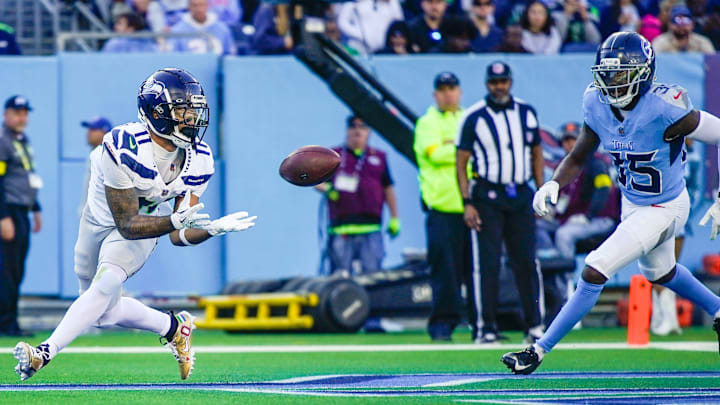 Seattle Seahawks wide receiver Jaxon Smith-Njigba (11) catches a touchdown pass around Tennessee Titans cornerback Samuel Womack III (35) during the third quarter at Nissan Stadium in Nashville, Tenn., Sunday, Nov. 23, 2025.