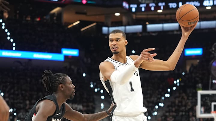 San Antonio Spurs forward Victor Wembanyama looks to pass against Portland Trail Blazers guard Jrue Holiday.