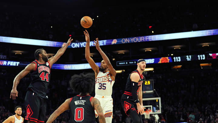 Jan 22, 2024; Phoenix, Arizona, USA; Phoenix Suns forward Kevin Durant (35) makes the go ahead basket over Chicago Bulls forward Patrick Williams (44) and Chicago Bulls guard Alex Caruso (6) during the second half at Footprint Center. Mandatory Credit: Joe Camporeale-Imagn Images