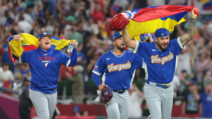 Venezuela pitcher José Buttó, right, and teammates celebrate after defeating Italy