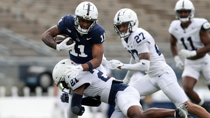 Penn State football wide receiver Kyron Hudson running with the ball as safety Vaboue Toure attempts to tackle