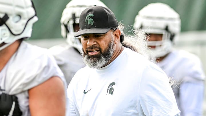Michigan State's defensive line coach Legi Suiaunoa works with players during the first day of football camp on Tuesday, July 30, 2024, in East Lansing.