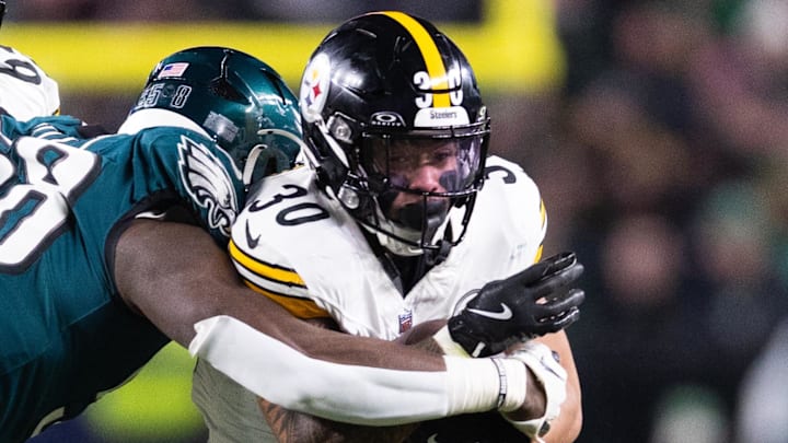 Dec 15, 2024; Philadelphia, Pennsylvania, USA; Pittsburgh Steelers running back Jaylen Warren (30) runs with the ball against Philadelphia Eagles linebacker Jalyx Hunt (58) during the second quarter at Lincoln Financial Field. Mandatory Credit: Bill Streicher-Imagn Images