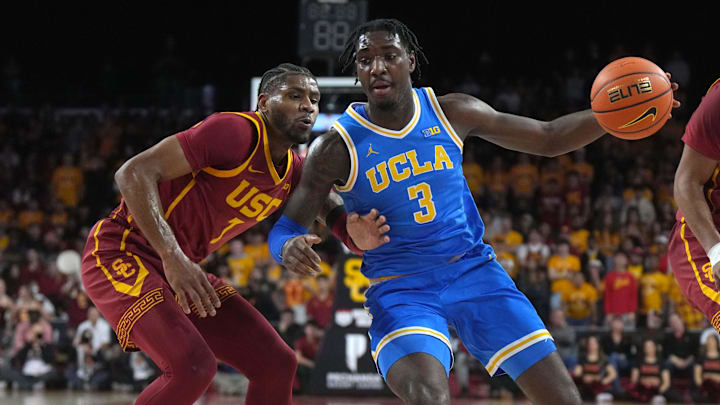 Jan 27, 2025; Los Angeles, California, USA; UCLA Bruins guard Eric Dailey Jr. (3) dribbles the ball against Southern California Trojans guard Chibuzo Agbo (7) and forward Saint Thomas (0) in the first half at Galen Center. Mandatory Credit: Kirby Lee-Imagn Images