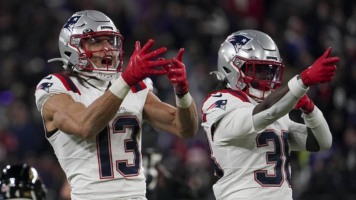Dec 21, 2025; Baltimore, Maryland, USA;  New England Patriots wide receiver Mack Hollins (13) celebrates a catch against Baltimore Ravens safety Kyle Hamilton (14) with New England Patriots running back Rhamondre Stevenson (38) during the first half of the game at M&T Bank Stadium. Mandatory Credit: James Lang-Imagn Images