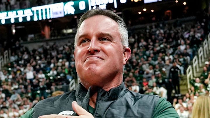 Michigan State's new football coach Pat Fitzgerald pats his heart at the crowd in attendance for the Spartans basketball game against Iowa on Tuesday, Dec. 2, 2025, at the Breslin Center in East Lansing.