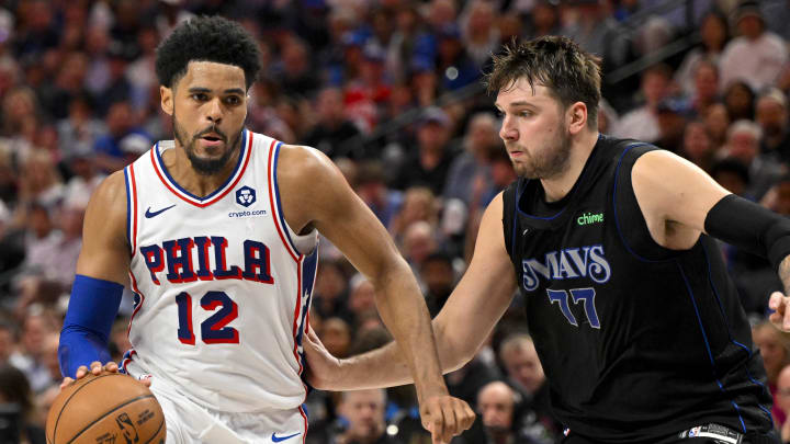 Mar 3, 2024; Dallas, Texas, USA; Philadelphia 76ers forward Tobias Harris (12) drives to the basket past Dallas Mavericks guard Luka Doncic (77) during the first half at the American Airlines Center. Mandatory Credit: Jerome Miron-USA TODAY Sports