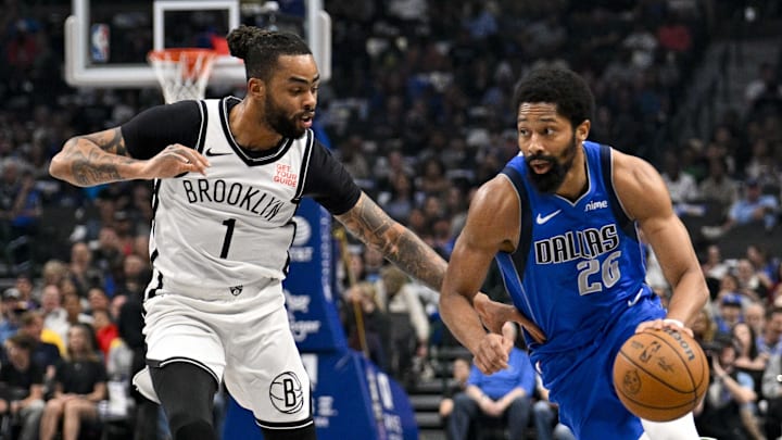 Mar 31, 2025; Dallas, Texas, USA; Dallas Mavericks guard Spencer Dinwiddie (26) brings the ball up court past Brooklyn Nets guard D'Angelo Russell (1) during the first quarter at the American Airlines Center. Mandatory Credit: Jerome Miron-Imagn Images