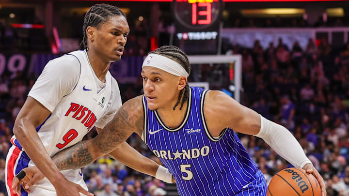 Apr 6, 2026; Orlando, Florida, USA; Orlando Magic forward Paolo Banchero (5) drives past Detroit Pistons guard Ausar Thompson (9) during the second half at Kia Center. Mandatory Credit: Mike Watters-Imagn Images