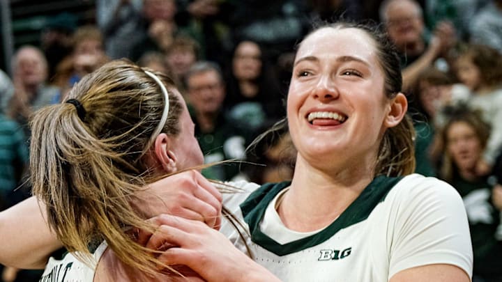 Michigan State's Julia Ayrault (40) and Grace VanSlooten (14) celebrate after going 10-0 and defeating Iowa 68-66 at the Breslin Center Sunday, Dec. 15, 2024.