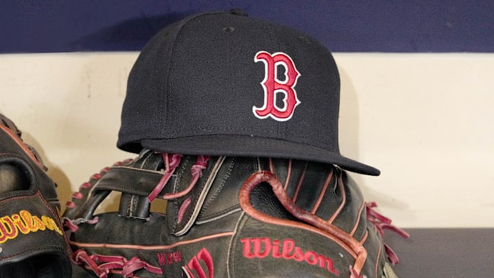 May 27, 2025; Milwaukee, Wisconsin, USA; A Boston Red Sox hat and glove sit in the dug out before a game against the Milwaukee Brewers at American Family Field. 