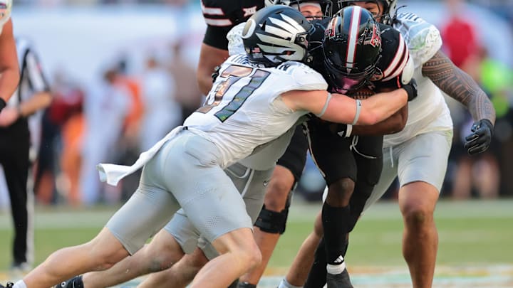 Jan 1, 2026; Miami Gardens, FL, USA; Texas Tech Red Raiders running back J'Koby Williams (20) is tackled by Oregon Ducks defensive back Dillon Thieneman (31) during the second half of the 2025 Orange Bowl and quarterfinal game of the College Football Playoff at Hard Rock Stadium. Mandatory Credit: Sam Navarro-Imagn Images