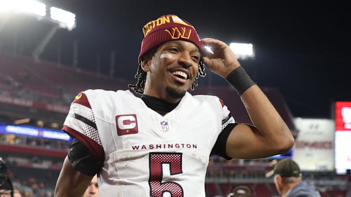 Jan 12, 2025; Tampa, Florida, USA; Washington Commanders quarterback Jayden Daniels (5) celebrates after winning a NFC wild card playoff against the Tampa Bay Buccaneers at Raymond James Stadium. Mandatory Credit: Nathan Ray Seebeck-Imagn Images