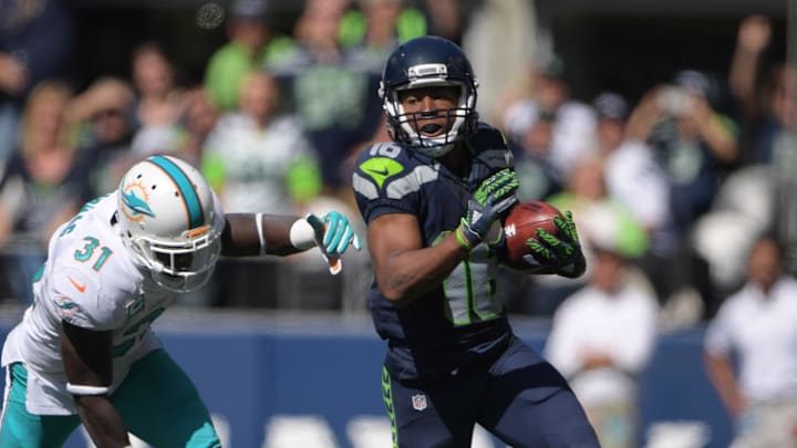 Sep 11, 2016; Seattle, WA, USA; Seattle Seahawks wide receiver Tyler Lockett (16) is pursued by Miami Dolphins free safety Michael Thomas (31) during a NFL game at CenturyLink Field. Mandatory Credit: Kirby Lee-Imagn Images