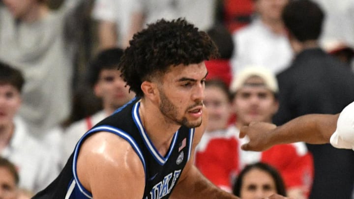 Mar 2, 2026; Raleigh, North Carolina, USA;  Duke Blue Devils forward Cameron Boozer (12) guards NC State Wolfpack guard Quadir Copeland (11) during the second half at Lenovo Center. Mandatory Credit: Zachary Taft-Imagn Images
