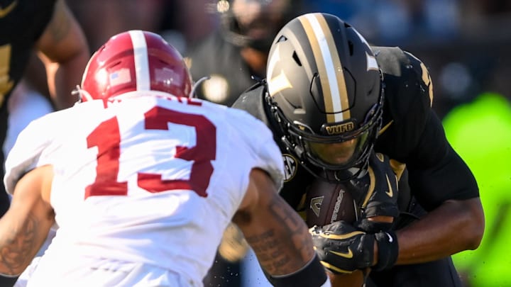 Oct 5, 2024; Nashville, Tennessee, USA; Alabama Crimson Tide defensive back Malachi Moore (13) tackles Vanderbilt Commodores running back AJ Newberry (23) during the first half at FirstBank Stadium. Oct 5, 2024; Nashville, Tennessee, USA; Alabama Crimson Tide defensive back Malachi Moore (13) tackles Vanderbilt Commodores running back AJ Newberry (23) during the first half at FirstBank Stadium.