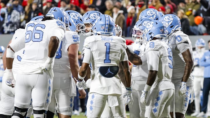 Nov 29, 2025; Raleigh, North Carolina, USA; North Carolina Tar Heels huddles during the first half of the game against NC State Wolfpack at Carter-Finley Stadium.  Mandatory Credit: Jaylynn Nash-Imagn Images