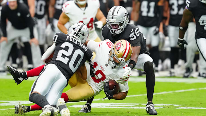 Aug 16, 2025; Paradise, Nevada, USA; San Francisco 49ers wide receiver Isaiah Hodgins (18) is tackled by Las Vegas Raiders cornerback Kyu Blu Kelly (36) and Las Vegas Raiders safety Isaiah Pola-Mao (20) during the first quarter at Allegiant Stadium. Mandatory Credit: Stephen R. Sylvanie-Imagn Images Aug 16, 2025; Paradise, Nevada, USA; San Francisco 49ers wide receiver Isaiah Hodgins (18) is tackled by Las Vegas Raiders cornerback Kyu Blu Kelly (36) and Las Vegas Raiders safety Isaiah Pola-Mao (20) during the first quarter at Allegiant Stadium. Mandatory Credit: Stephen R. Sylvanie-Imagn Images