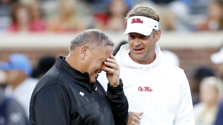 Arkansas Razorbacks coach Sam Pittman and Ole Miss Rebels coach Lane Kiffin talk prior to the game at Vaught-Hemingway Stadium.
