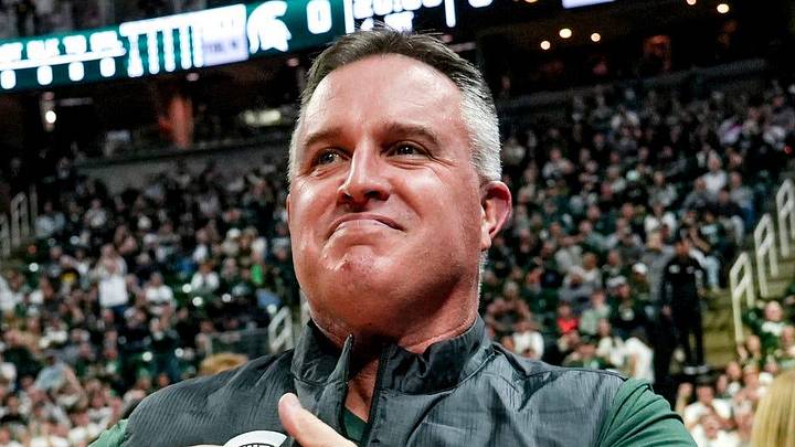 Michigan State's new football coach Pat Fitzgerald pats his heart at the crowd in attendance for the Spartans basketball game against Iowa on Tuesday, Dec. 2, 2025, at the Breslin Center in East Lansing.