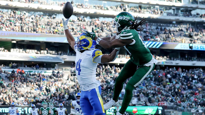 Dec 22, 2024; East Rutherford, New Jersey, USA; Los Angeles Rams cornerback Ahkello Witherspoon (4) breaks up a pass intended for New York Jets wide receiver Davante Adams (17) during the third quarter at MetLife Stadium. Mandatory Credit: Brad Penner-Imagn Images