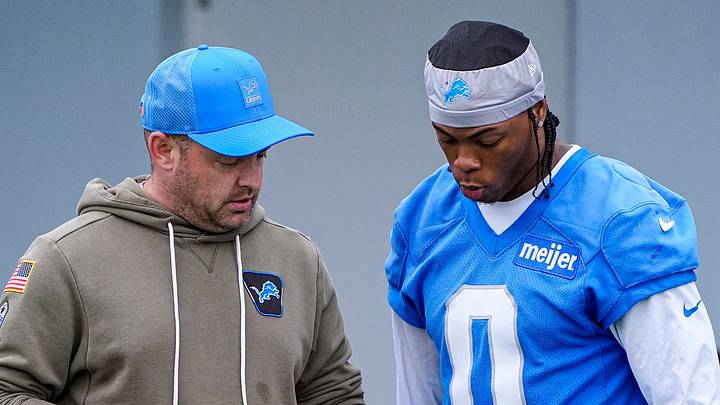 Detroit Lions offensive coordinator Drew Petzing, left, talks to running back Jahmyr Gibbs (0) before OTAs at Meijer Performance Center in Allen Park on Thursday, June 11, 2026. Detroit Lions offensive coordinator Drew Petzing, left, talks to running back Jahmyr Gibbs (0) before OTAs at Meijer Performance Center in Allen Park on Thursday, June 11, 2026.