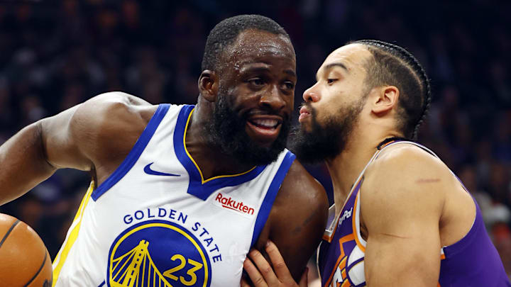 Dec 18, 2025; Phoenix, Arizona, USA; Golden State Warriors forward Draymond Green (23) against Phoenix Suns forward Dillon Brooks in the first half at Mortgage Matchup Center. Mandatory Credit: Mark J. Rebilas-Imagn Images