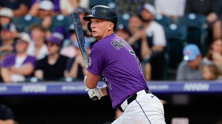 Colorado Rockies first baseman TJ Rumfield (7) hits an RBI single. 