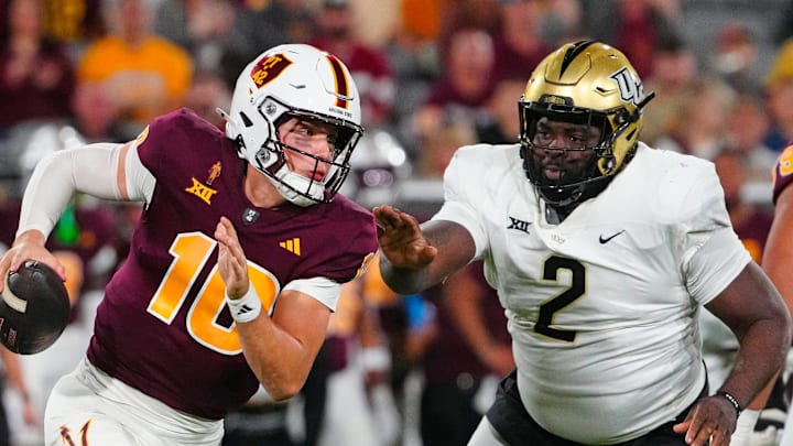 ASU quarterback Sam Leavitt (10) scrambles against UCF defensive tackle Lee Hunter (2) during a game at Mountain America Stadium in Tempe on Nov. 9, 2024.